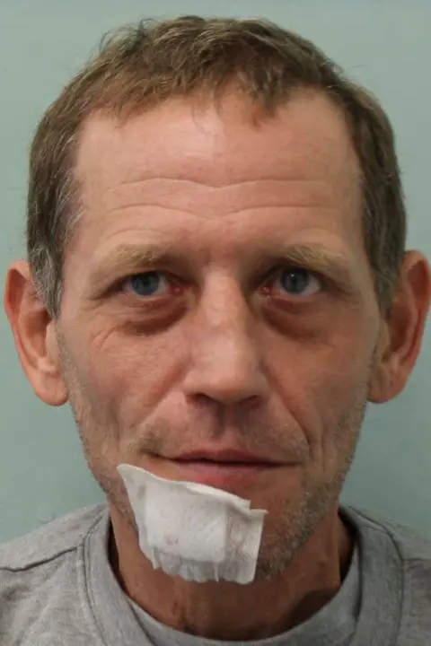 Metropolitan police A custody shot of Daniel Whybrow, he has a white dressing on his chin