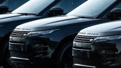 Getty Images A row of black Land Rover cars