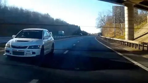 Gwent Police Footage of a rear window camera catches a white sports car speeding past