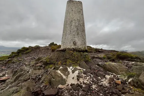 Ashes lie in a pile all over the top of the Scottish hill, Dumyat.