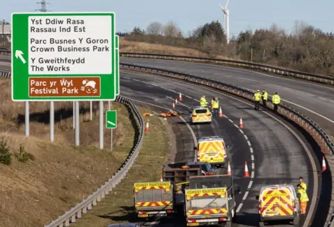 Getty Images Maintenance vehicles blocked off a dual carriageway road as police investigate a serious crash as bollards block the road