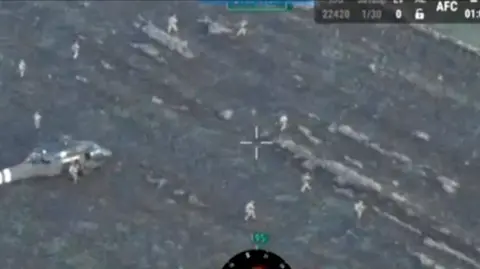 Reuters Drone shot of Ukrainian forces leaving a helicopter in a muddy field.