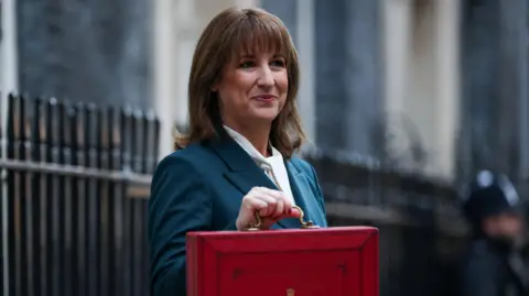 Reuters Chancellor Rachel Reeves standing in Downing Street with her Budget red box.