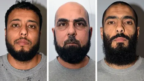 Greater Manchester Police Mugshots of Walid Saadaoui, Amar Hussein and Bilel Saadaoui. They all wear grey t-shirts. Saadaoui has short dark hair and a dark beard. Hussein is bald and has a short dark beard Bilel Saadaoui has short dark hair and a medium length dark beard