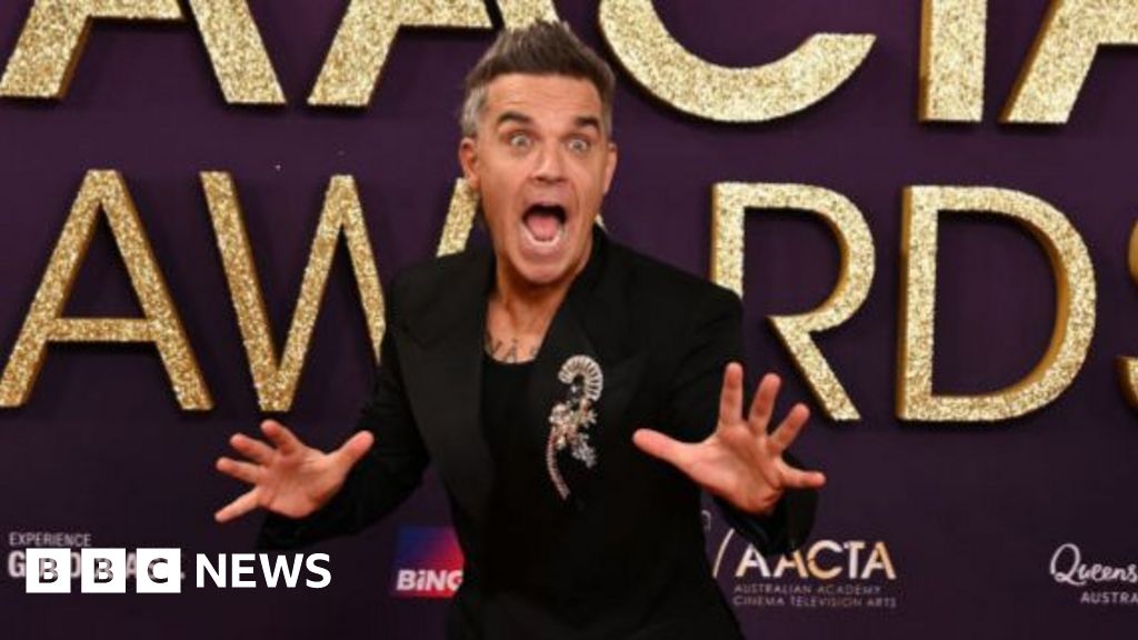 Take That singer Robbie Williams surprises 94-year-old fan