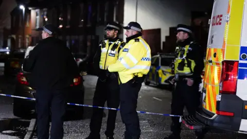 Jacob King/PA Wire Police officers in Derby, following a controlled explosion which has taken place at the scene of a major incident where more than 200 homes have been evacuated
