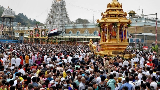 Devotees take part in the golden chariot procession of the Lord Venkateswara temple on the occasion of Vaikuntha Ekadasi, at Tirumala in Tirupati. (File/PTI)