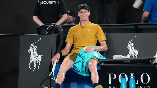 Jannik Sinner overcomes cramps, heat to continue his title defense at Australian Open