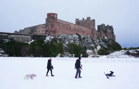 PA Media Bamburgh Castle surrounded by snow in Northumberland
