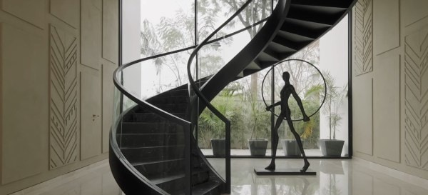 A spiral staircase connects the two floors of Ananda. Credit: 23DC Architects.